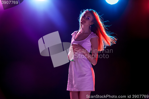 Image of The beautiful girl dancing at the party drinking champagne
