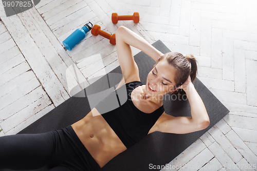 Image of Beautiful slim brunette  doing some push ups a the gym