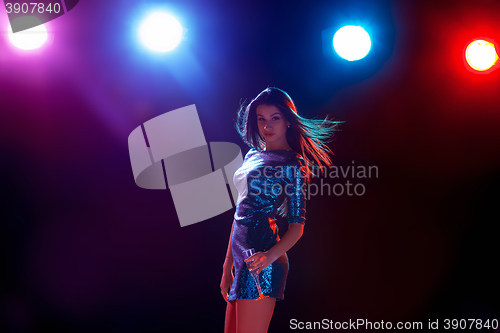 Image of The beautiful girl dancing at the party drinking champagne
