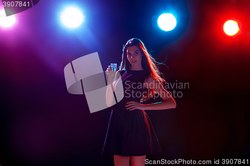 Image of The beautiful girl dancing at the party drinking champagne