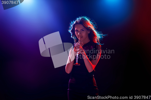 Image of The beautiful girl dancing at the party drinking champagne