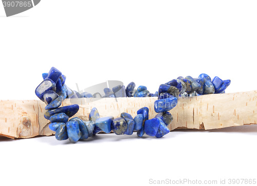 Image of Splintered lapis lazuli chain on wood