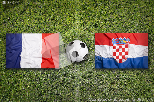 Image of France vs. Croatia flags on soccer field