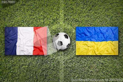 Image of France vs. Ukraine flags on soccer field