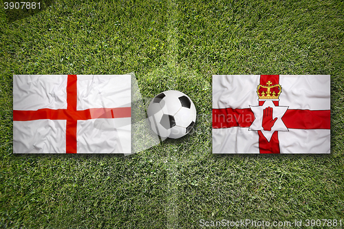 Image of England vs. Northern Ireland flags on soccer field