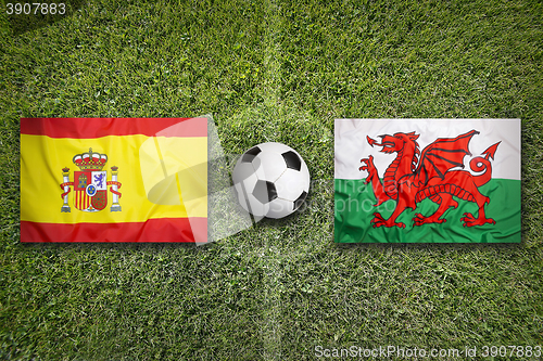 Image of Spain vs. Wales flags on soccer field