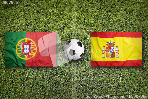 Image of Portugal vs. Spain flags on soccer field