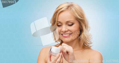 Image of happy woman with cream jar
