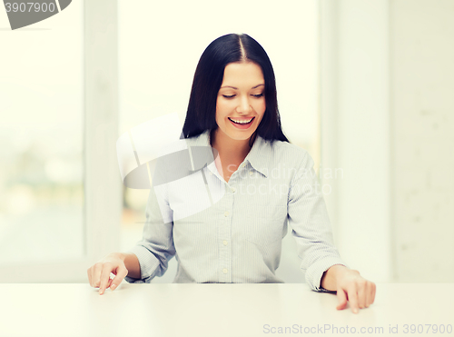 Image of smiling woman pointing to something imaginary