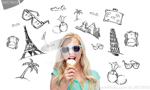 Image of happy young woman in sunglasses eating ice cream