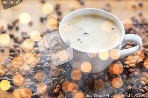 Image of close up coffee cup and grains on wooden table