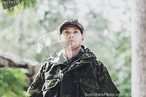 Image of young soldier or ranger in forest