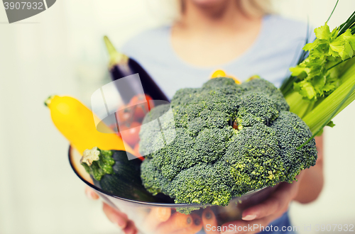 Image of close up of woman holding vegetables in bowl