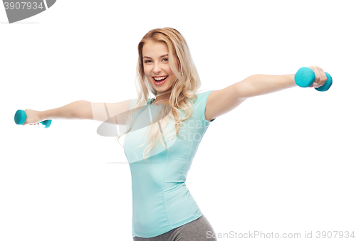 Image of smiling beautiful young sporty woman with dumbbell