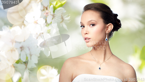 Image of beautiful asian woman with earring and pendant