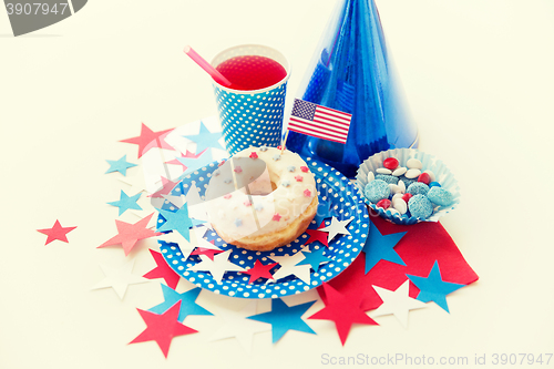 Image of donut with juice and candies on independence day