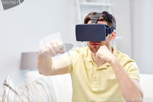 Image of young man in virtual reality headset or 3d glasses