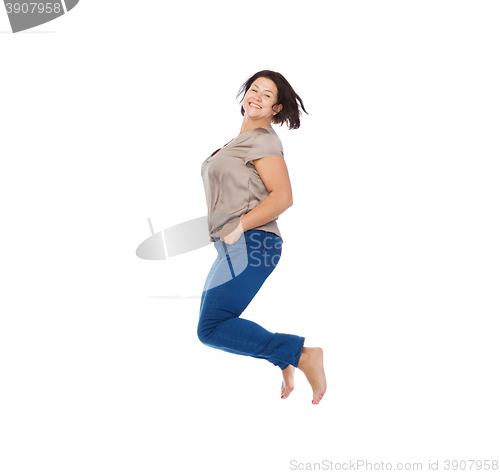 Image of smiling happy plus size woman jumping high in air