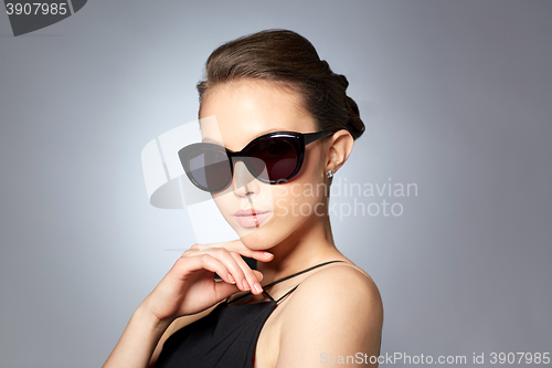 Image of beautiful young woman in elegant black sunglasses