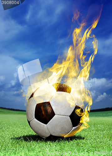 Image of fiery soccer ball on grass