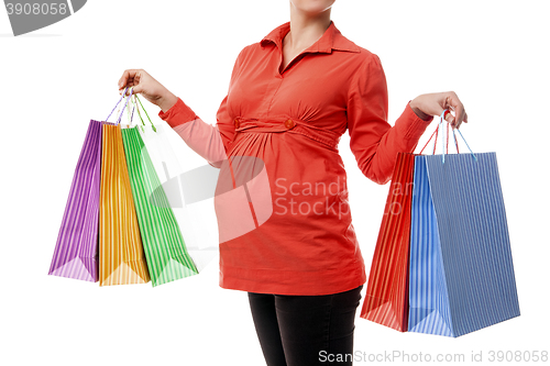 Image of Pregnant woman holding shopping bags isolated