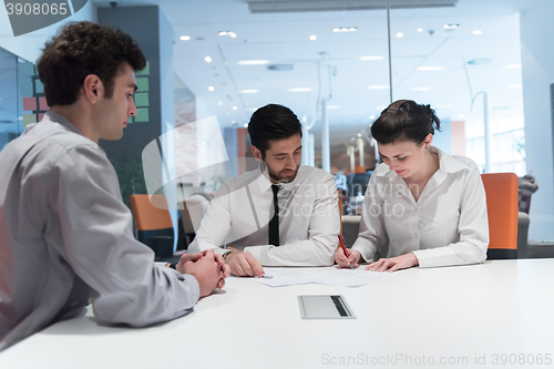 Image of young couple signing contract documents on partners back