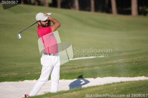 Image of golfer hitting a sand bunker shot