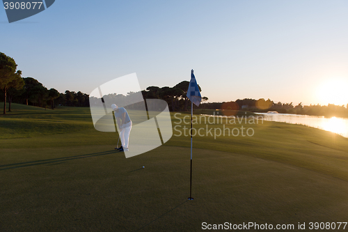 Image of golfer hitting ball to hole