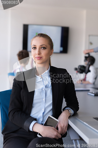 Image of portrait of young business woman at office with team on meeting 