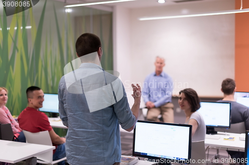 Image of student answering a question in classroom