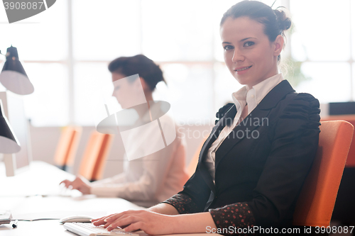 Image of business woman at  office people group in background