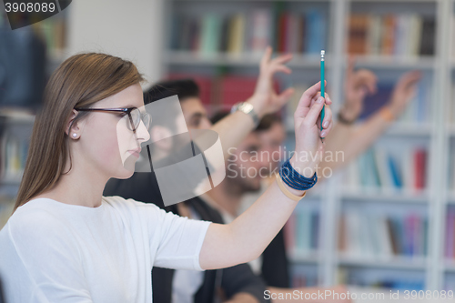 Image of group of students  raise hands up