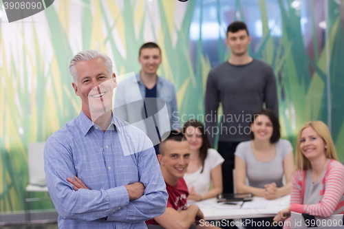 Image of portrait of  teacher with students group in background