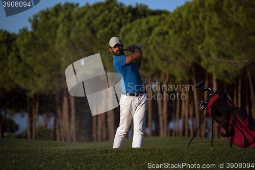 Image of golfer hitting a sand bunker shot on sunset