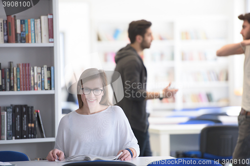 Image of female student study in school library, group of students in bac