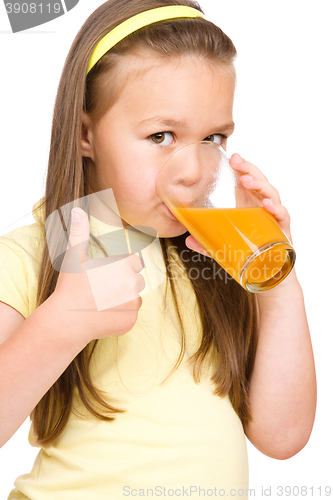 Image of Little girl is drinking orange juice