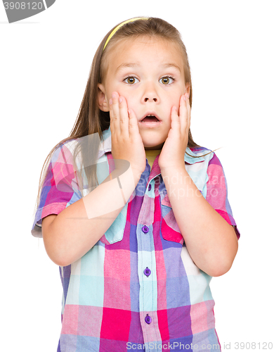 Image of Little girl is holding her face in astonishment