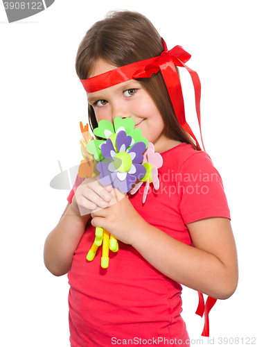 Image of Cute little girl wit a bunch of flowers