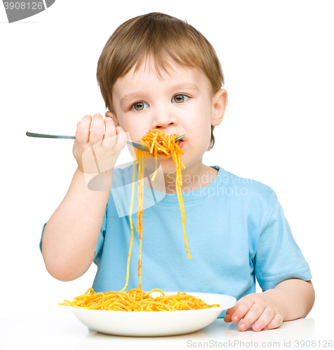 Image of Little boy is eating spaghetti