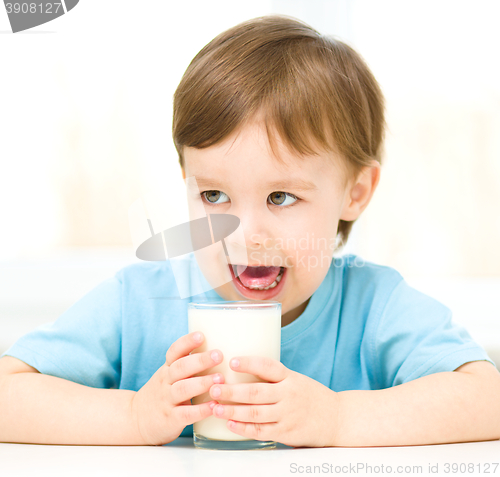 Image of Cute little boy with a glass of milk