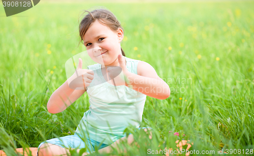 Image of Little girl is showing thumb up gesture