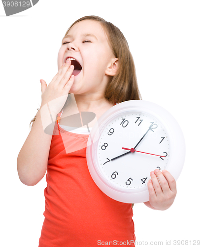 Image of Little girl is holding big clock