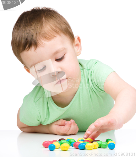 Image of Portrait of a boy with candies
