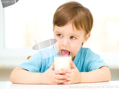 Image of Cute little boy with a glass of milk