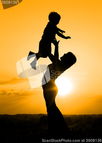Image of Silhouette of mother playing with her son