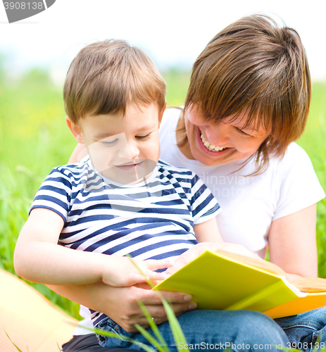 Image of Mother is reading book for her child