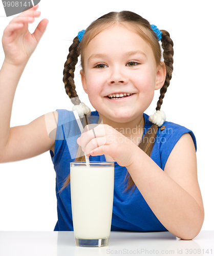 Image of Cute little girl with a glass of milk