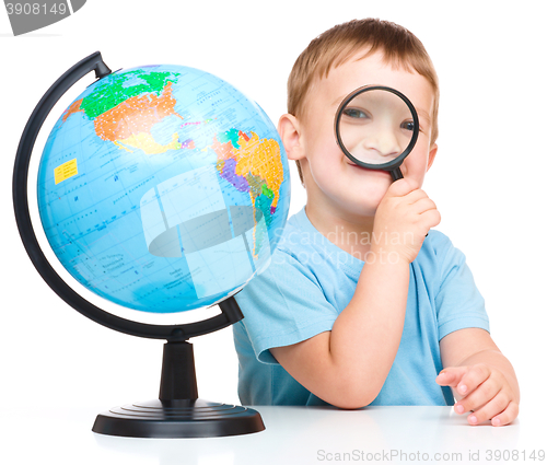 Image of Happy little boy with a globe