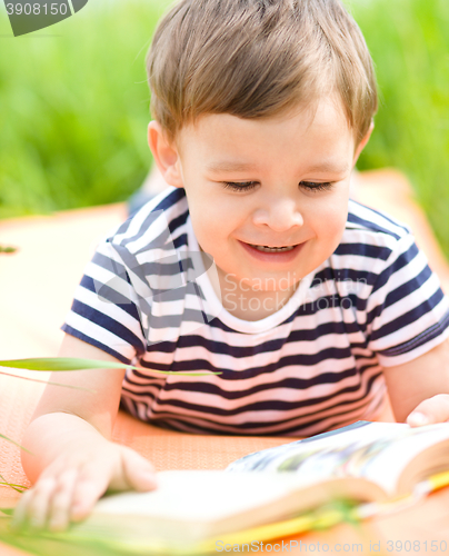 Image of Little boy is reading book