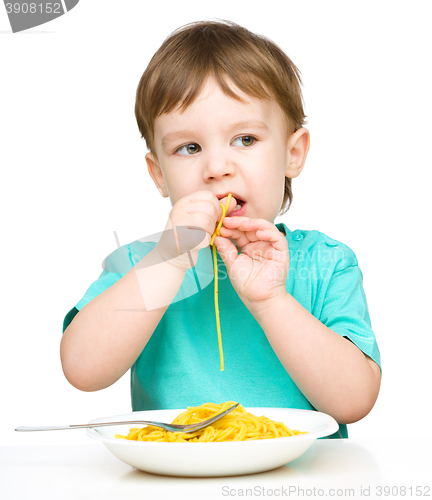 Image of Little boy is eating spaghetti